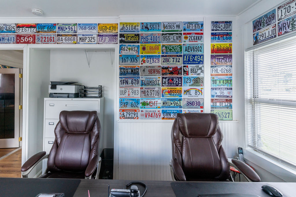 Hilson Ink office wall lined with custom license plate graphics — Areas We Serve
